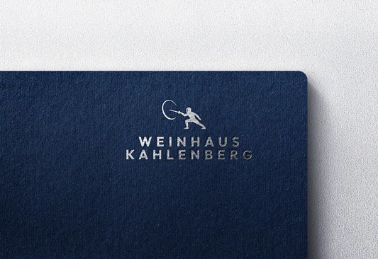 The Weinhaus Kahlenberg mark, a fencer mid-lunge above the name in spaced capitals, foil-stamped on navy card